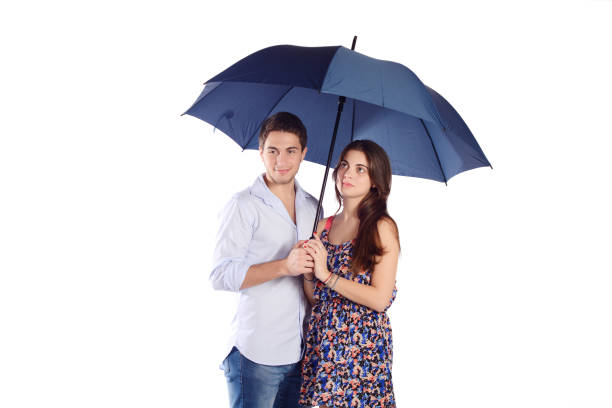 istock Couple holding umbrella 667563902