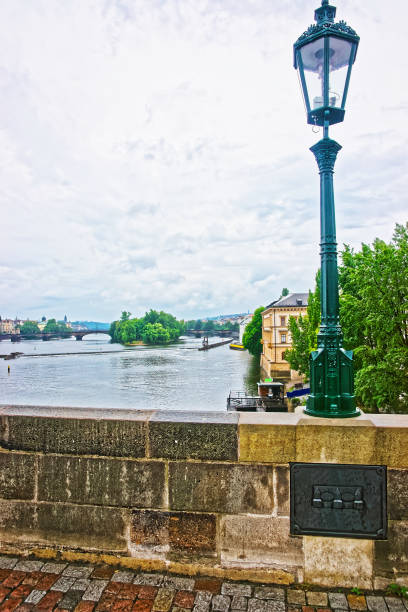 istock Lantern at Charles Bridge over Vltava River in Prague 667565078