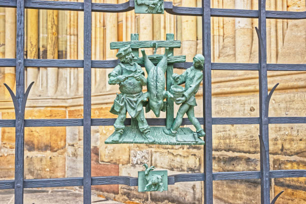 Emblem of a pig being cooked in ancient method at the entrance door of one of the pubs in Prague, Czech Republic