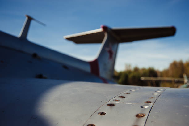 Wing of old airplane. Scratched fuselage. Rusty bolts. Antiquated planes.