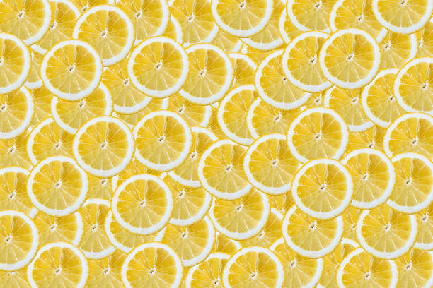 istock Slices of lemons background 667568324