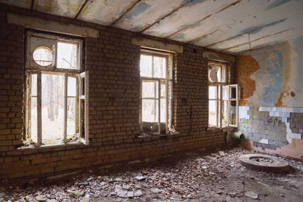 istock Abandoned large hall with big windows and debris 667568442