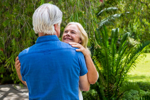 istock Romantic senior couple embraing at park 667576780