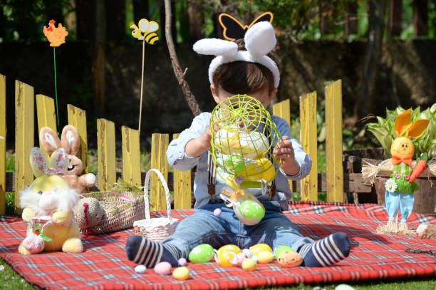 istock Little boy on the meadow celebrates Easter 667577614