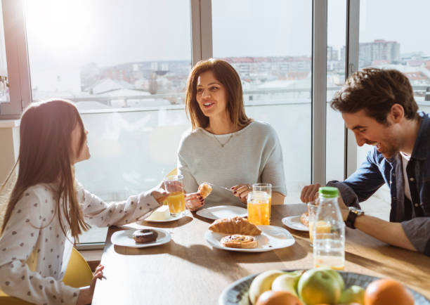 istock cheerful young family having breakfast together 667578414