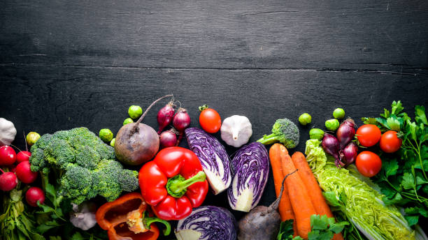 istock Big set organic food. Fresh raw vegetables. On a black chalkboard. 667580598