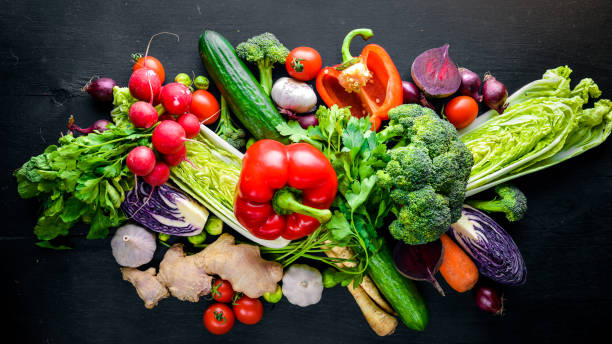 istock Big set organic food. Fresh raw vegetables. On a black chalkboard. 667580838