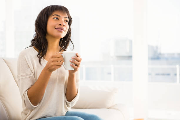 istock Smiling woman drinking a coffee 667581564