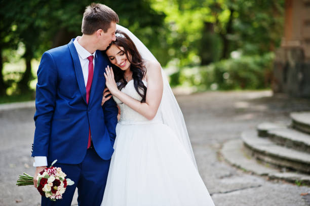 istock Wedding couple in love hugging at park at sunny day. 667584510