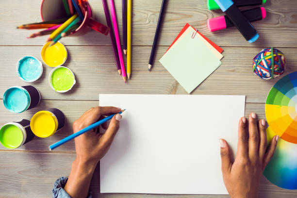 istock Graphic designer drawing on sheet of paper 667595852