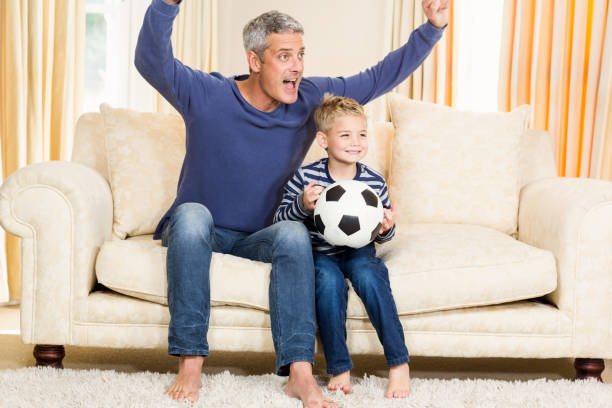 istock Father and son exulting on the sofa 667595988