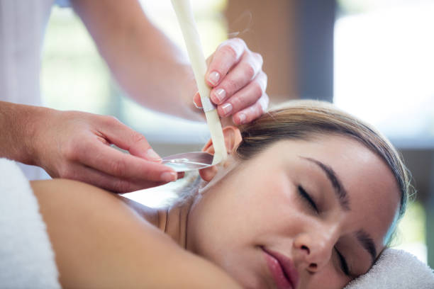 istock Woman receiving ear candle treatment 667596314