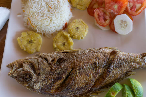 istock plate of fried fish with plantains 667598488