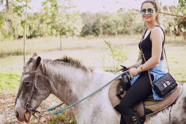 istock girl preparing to ride a horse 667600160