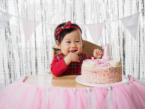 front view of baby girl celebrate her first birthday