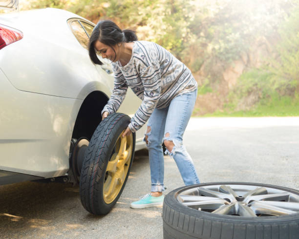 istock Young Women Changing A Flat Tire 667607310