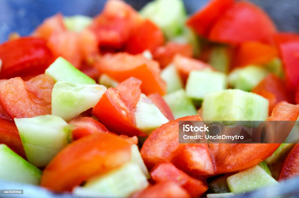 Sliced cucumbers and tomatoes close up. Sliced cucumbers and tomatoes close up. Horizontal view. Bright Stock Photo