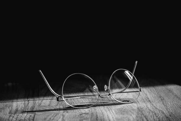 istock Busines like of elegant modern eyeglasses spectacles pair with thin titanium rim on office table 667611162