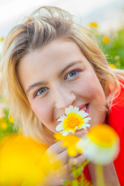 istock Young attractive woman smiling between the flowers 667617368