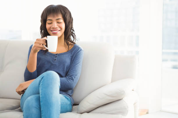 istock Smiling casual woman drinking coffee 667621578