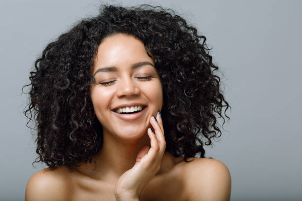 istock Smiling woman with bare shoulders and closed eyes 667624102