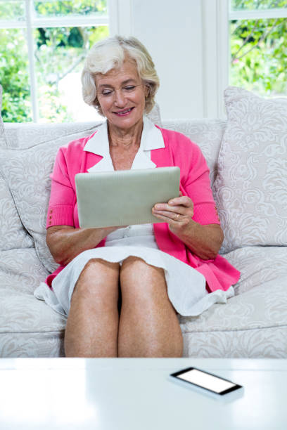 istock Senior woman using digital tablet at home 667625336