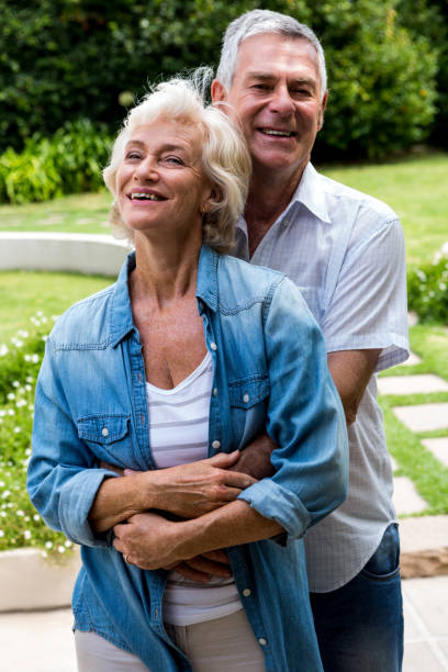 istock Portrait of senior man embracing from behind in back yard 667629018
