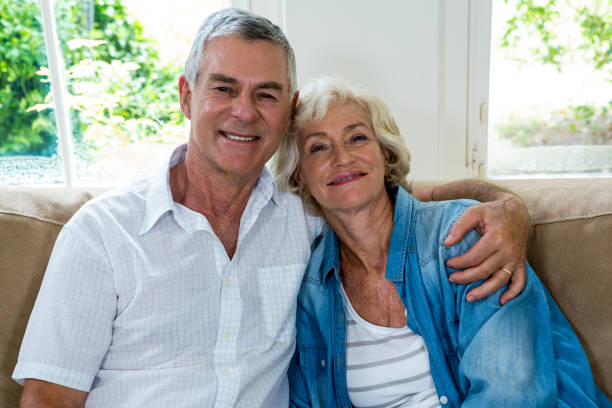 istock Portrait of senior couple on sofa 667629218
