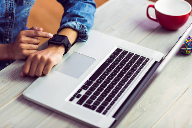 istock Casual businesswoman using her smart watch 667629734