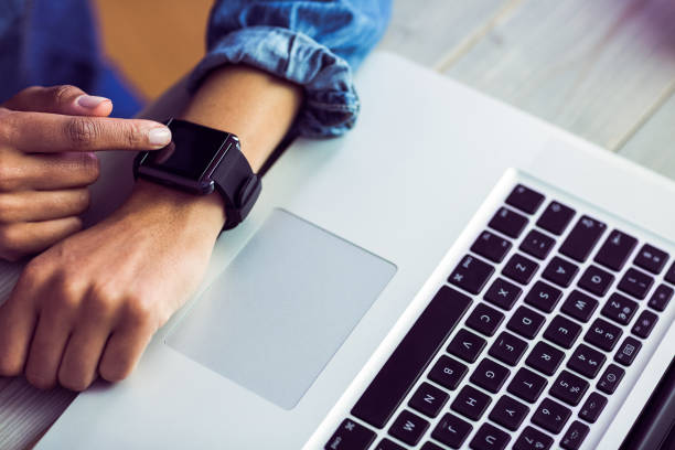 istock Casual businesswoman using her smart watch 667629752