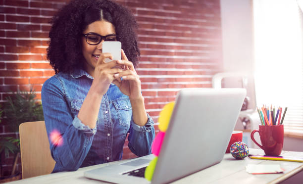 istock Casual businesswoman using her smartphone 667630016