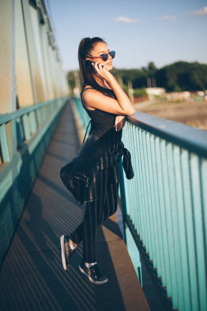 istock Young attractive girl walking over the bridge 667632622