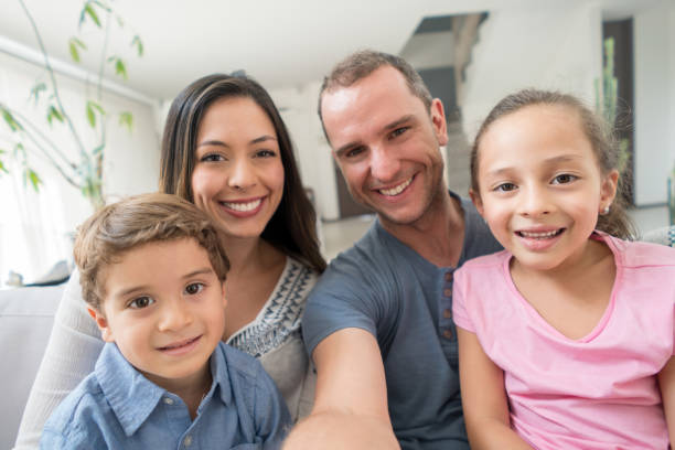 istock Happy family at home taking a selfie 667633208