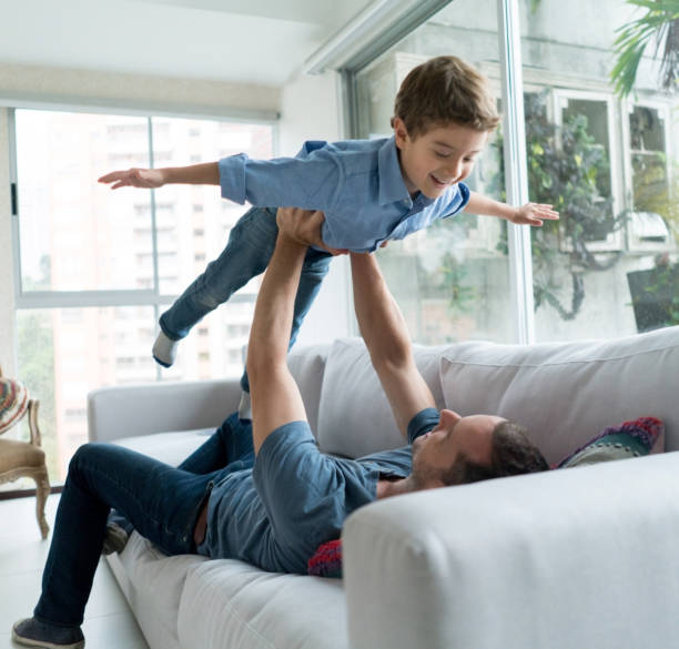 istock Boy playing with his father at home 667633306