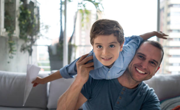 istock Happy father playing at home with his son 667633322