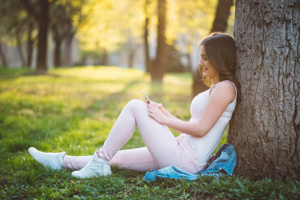 istock teenager girl using phone 667638208