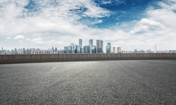 istock empty road with cityscape of modern city 667645626