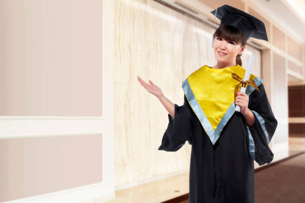 istock Beautiful asian woman using graduation cap and holding certificate 667648582
