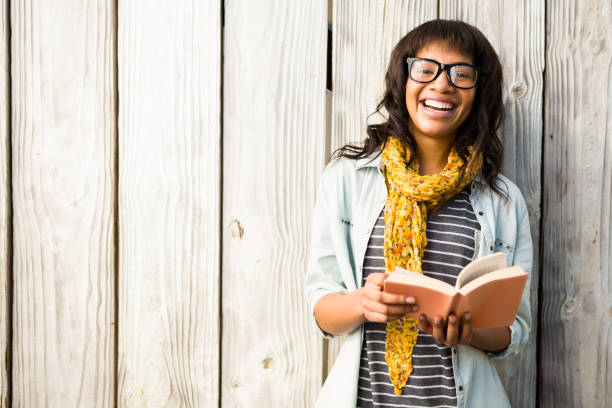 istock Smiling casual woman reading a book 667649844