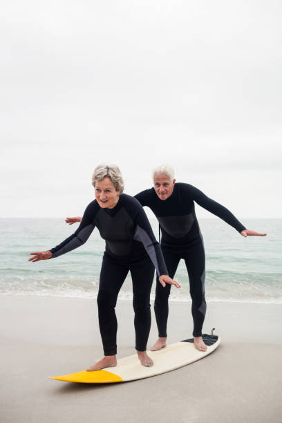 istock Senior couple surfing on beach 667652594
