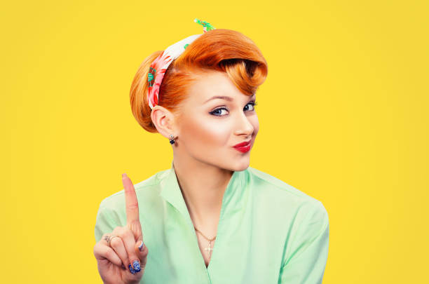 woman gesturing a no sign. Closeup portrait unhappy, serious pinup retro style girl raising finger up saying oh no you did not do that yellow background. Negative emotions facial expressions, feelings stock photo