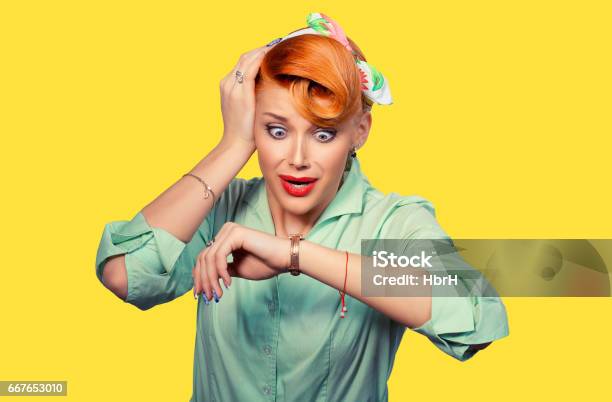 Woman Being Late Closeup Portrait Headshot View Stressed Young Attractive Beautiful Businesswoman Checking The Time Being Late To A Business Meeting To A Rendezvous Date Isolated Yellow Background Stock Photo - Download Image Now