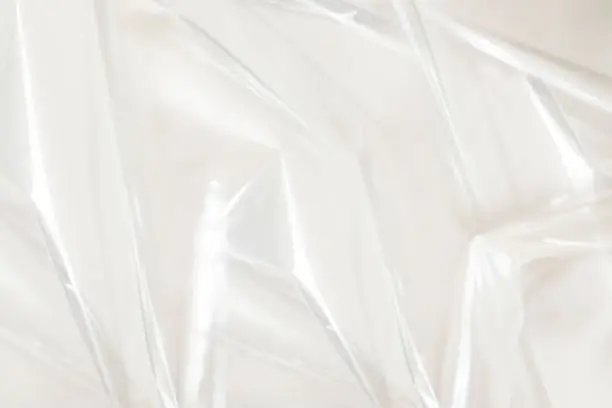 White texture of a plastic cellophane film that can be used as background in related contexts.