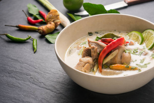 istock Chicken coconut soup (Tom Kha Gai), Thai food on black stone table background 667656602