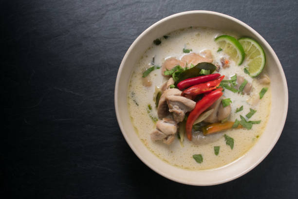 istock Chicken coconut soup (Tom Kha Gai), Thai food on black stone table background 667656606