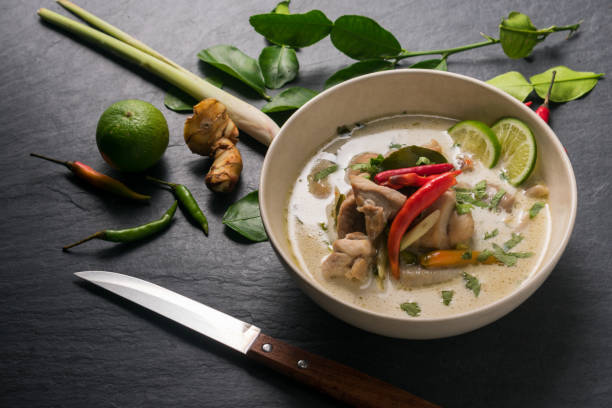 istock Chicken coconut soup (Tom Kha Gai), Thai food on black stone table background 667656624
