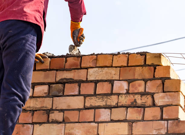 istock Worker builds a brick wall in the house 667657046