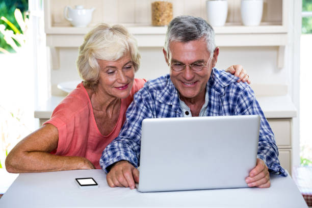 istock Senior couple using laptop at home 667657090