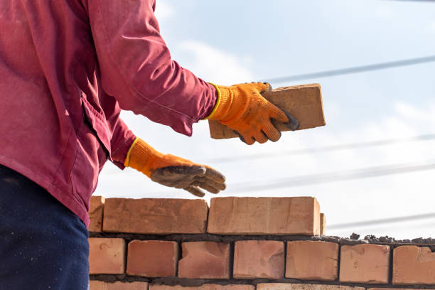 istock Worker builds a brick wall in the house 667657136