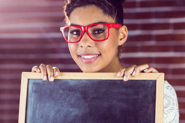istock A female hipster holding a blackboard 667657590